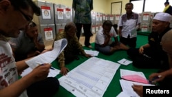 Perhitungan kertas suara oleh anggota KPU di Bendungan Hilir, Jakarta Pusat (10/7). (Reuters/Beawiharta)