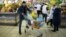  FILE - A man pushes a cart with food items at a grocery store in Moscow, April 2, 2015.