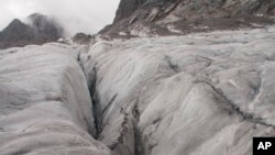 FILE -An ice crevasse is seen on the Baishui Glacier No. 1, the world's fastest melting glacier due to its proximity to the Equator, on the Jade Dragon Snow Mountain in the southern province of Yunnan in China, Sept. 22, 2018.