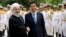 Japanese Prime Minister Shinzo Abe, center, shakes hands with Iranian President Hassan Rouhani during the official arrival ceremony, at the Saadabad Palace in Tehran, Iran, June 12, 2019.