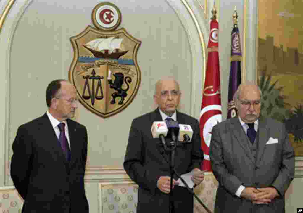 In this photo provided by the presidency, Prime Minister of Tunisia, Mohammed Ghannouchi, centre, is about to address the nation to announce that he is assuming power in Tunis, 14 Jan 2011
