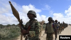 FILE - African Union Mission in Somalia (AMISOM) peacekeepers from Burundi patrol after fighting between insurgents and government soldiers erupted on the outskirts of Mogadishu.