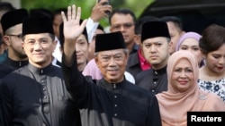 Malaysia's Prime Minister Designate and former interior minister Muhyiddin Yassin waves to reporters before his inauguration as the 8th prime minister, outside his residence in Kuala Lumpur, Malaysia, March 1, 2020. REUTERS/Lim Huey Teng TPX…