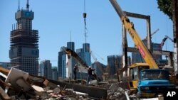 FILE- Workers move a steel frame at a new development project in central Beijing, China, June 30, 2015. The U.N. is concerned that human rights safeguards will not be a priority on China-backed development projects abroad.