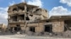 A building damaged by Syrian government forces following clashes with rebel fighters is seen in the southern city of Daraa, Syria, Sept 12, 2021.