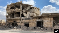 A building damaged by Syrian government forces following clashes with rebel fighters is seen in the southern city of Daraa, Syria, Sept 12, 2021.