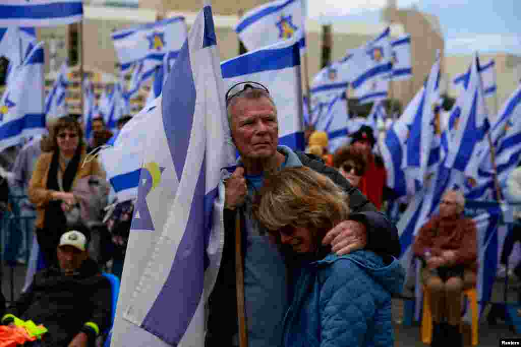 People gather, on the day the bodies of deceased Israeli hostages, Oded Lifschitz, Shiri Bibas and her two children Kfir and Ariel Bibas, who were kidnapped during the deadly October 7, 2023 attack by Hamas, are handed over under the terms of a ceasefire between Hamas and Israel, in Tel Aviv, Israel.