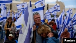 People gather, on the day the bodies of deceased Israeli hostages, Oded Lifschitz, Shiri Bibas and her two children Kfir and Ariel Bibas, who were kidnapped during the deadly October 7, 2023 attack by Hamas, are handed over under the terms of a ceasefire between Hamas and Israel, in Tel Aviv, Israel.