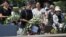Clifton Truman Daniel (C) offers a wreath of flowers at the memorial cenotaph for the people killed by the atomic bomb at the Peace Memorial Park in Hiroshima, Japan, August 4, 2012.