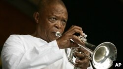 FILE - In an April 29, 2006 file photo, Hugh Masekela performs during the 2006 New Orleans Jazz and Heritage Festival in New Orleans. 