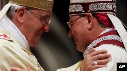 Mons. Fabio Fabene, right, is embraceed by Pope Francis during his Episcopal Ordination, at the Vatican, May 30, 2014. (File Photo)