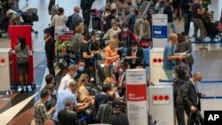 People queue to get on the Air France flight to Paris at OR Tambo's airport in Johannesburg, South Africa, Nov. 26, 2021. 