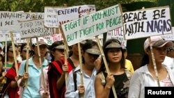 FILE - Activists of the National Socialist Council of Nagaland (NSCN) hold placards and shout slogans during a demonstration in New Delhi.