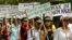 FILE - Activists of the National Socialist Council of Nagaland (NSCN) hold placards and shout slogans during a demonstration in New Delhi.