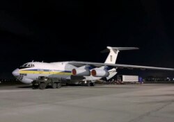 In this photo from the Ukrainian Presidential Press Office, the plane carrying Ukrainian experts prepares to depart for Tehran at Borispil international airport outside Kyiv, Ukraine, Jan. 8, 2020.