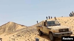 FILE - Tuareg rebel alliance fighters who clashed with Russian Wagner mercenaries are seen in northeastern Mali, near Tinzaouaten, Mali, July 2024, in this screen grab taken from a handout video. (Coordination of Azawad Movements/Handout via Reuters) 