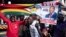 FILE: Supporters of MDC (Movement for Democratic Change Alliance) leader and opposition presidential candidate cheer outside the MDC headquarters in Harare, on July 31, 2018. 