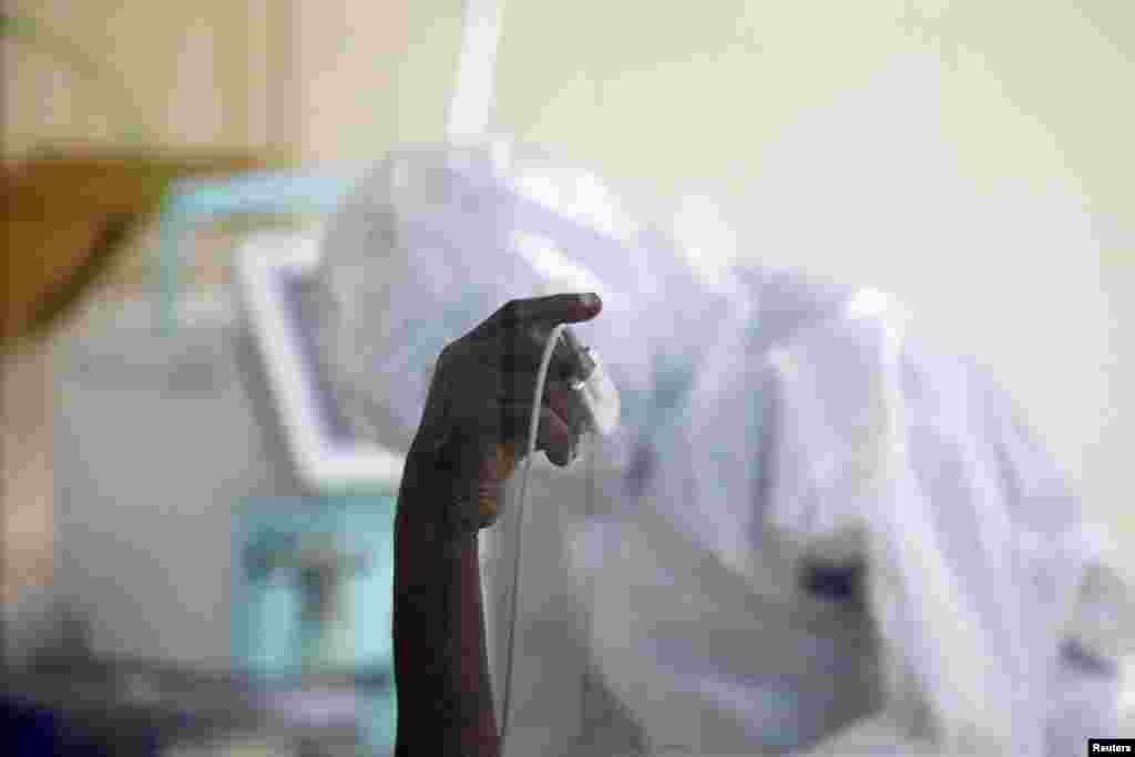 A coronavirus disease patient holds up his hand inside the COVID-19 ICU of Machakos Level 5 Hospital, in Machakos, Kenya, Oct. 28, 2020.