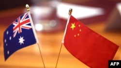 FILE - Chinese and Australian flags are displayed on a table at Parliament House in Canberra on March 20, 2024.