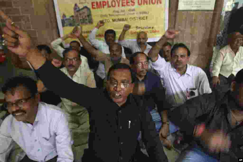 Employees of India's state-run telecommunications company protest the shutting down of the telegram service at the central telegraph office in Mumbai, July 14, 2013. 