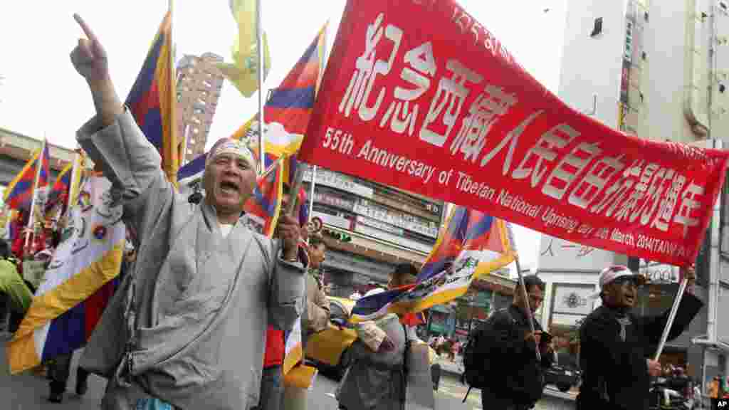 Tibetans living in Taiwan and supporters march during a protest to mark the March 10 anniversary in Taipei, Taiwan, Sunday, March 9, 2014. (AP Photo/Chiang Ying-ying)