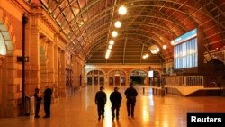 Police officers patrol through the quiet Central Station in the city center during a lockdown to curb the spread of COVID-19 outbreak in Sydney, Australia, Aug. 12, 2021.