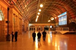 Police officers patrol through the quiet Central Station in the city center during a lockdown to curb the spread of COVID-19 outbreak in Sydney, Australia, Aug. 12, 2021.