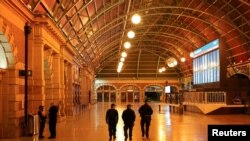 Police officers patrol through the quiet Central Station in the city center during a lockdown to curb the spread of COVID-19 outbreak in Sydney, Australia, Aug. 12, 2021.