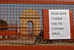A sign pasted on a security barricade is seen after the India Gate war memorial was closed for visitors amid measures for coronavirus prevention in New Delhi, India, March 19, 2020.