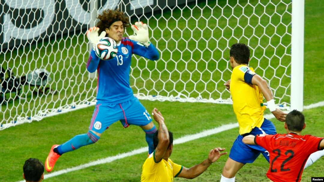 Penjaga gawang Meksiko, Guillermo Ochoa, menahan serangan tim Brazil dalam pertandingan Grup A (17/6). (Reuters/Mike Blake)