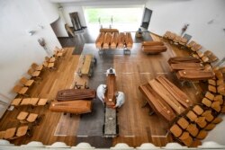 Coffins arriving from the Bergamo area are being unloaded from a military truck that transported them in the cemetery of Cinisello Balsamo, near Milan in Northern Italy, March 27, 2020.