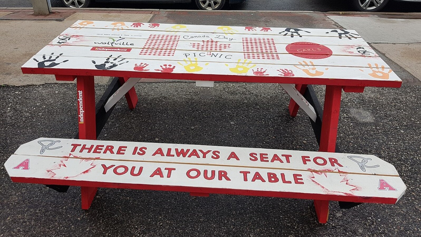 The message on this table in Wolfville, Nova Scotia, aligns with the town's attitude toward helping refugees. A community group from Wolfville has been among those in Canada to take primary responsibility for helping refugees become established in the country. (Wikimedia Commons)