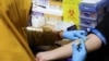 A staff member takes a blood sample during a free medical check-up for the public at the government-run healthcare center in Jakarta, Indonesia, Feb. 10, 2025.