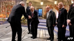 King Harald V of Norway, left, greets the representatives of the organization Nihon Hidankyo — Terumi Tanaka, Shigemitsu Tanaka and Toshiyuki Mimaki — after the group was awarded the 2024 Nobel Peace Prize on Dec. 10, 2024, at Oslo City Hall in Oslo, Norway.