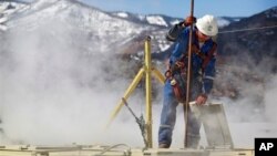 Worker checks water levels, temperatures in a series of tanks at an Encana Oil & Gas (USA) Inc. hydraulic fracturing operation at a gas drilling site outside Rifle, Colorado, March 29, 2013.