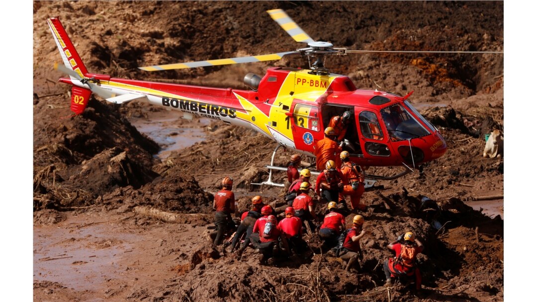 Members of a rescue team search for victims after a tailings dam owned by Brazilian mining company Vale SA collapsed, in Brumadinho, Brazil, Jan. 28, 2019.