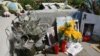 Flowers and candles are placed in front of the Santa Eugenia train Station near Madrid, March 10, 2006, in memory of the victims who died in the March 11, 2004 attacks in the Spanish capital. Ten bombs went off on four trains March 11, 2004, killing 191 peopel.