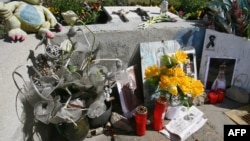 Flowers and candles are placed in front of the Santa Eugenia train Station near Madrid, March 10, 2006, in memory of the victims who died in the March 11, 2004 attacks in the Spanish capital. Ten bombs went off on four trains March 11, 2004, killing 191 peopel.