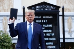 President Donald Trump holds a Bible as he visits outside St. John's Church across Lafayette Park from the White House Monday, June 1, 2020, in Washington. Park of the church was set on fire during protests on Sunday night. (AP Photo/Patrick…