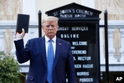FILE - President Donald Trump holds a Bible as he visits outside St. John's Church across Lafayette Park from the White House Monday, June 1, 2020, in Washington. (AP Photo/Patrick Semansky)