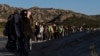 Chinese migrants wait to be processed after crossing the border with Mexico near Jacumba Hot Springs, Calif., May 8, 2024. San Diego was the busiest corridor for illegal crossings in April, according to U.S. figures.