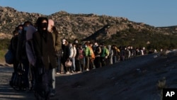 Chinese migrants wait to be processed after crossing the border with Mexico near Jacumba Hot Springs, Calif., May 8, 2024. San Diego was the busiest corridor for illegal crossings in April, according to U.S. figures.