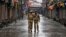 Indian policemen patrol a deserted street during a strike called by separatists to mark India's 67th Independence Day in Srinagar, August 15, 2013. 