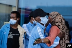 Survivors of a boat tragedy that killed 28 Somali migrants off the coast of Madagascar arrive at Aden Adde International Airport in Mogadishu, Somalia, on Dec. 7, 2024.