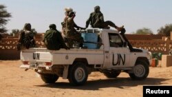 FILE - Chadian U.N. peacekeepers gesture as they patrol in Aguelhok, Mali.