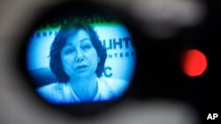 Syrian National Council representative, spokeswoman Basma Kodmani seen through a TV camera viewfinder answers a question during a news conference in Moscow, Russia, Tuesday, July 10, 2012. 