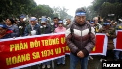 FILE - People take part in an anti-China protest to mark the 43rd anniversary of the China's occupation of the Paracel Islands in the South China Sea in Hanoi, Vietnam, Jan. 19, 2017.