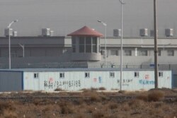 FILE.- A guard tower and barbed wire fences are seen around a facility in the Kunshan Industrial Park in Artux in western China's Xinjiang region, Dec. 3, 2018. This is one of a growing number of internment camps in Xinjiang.