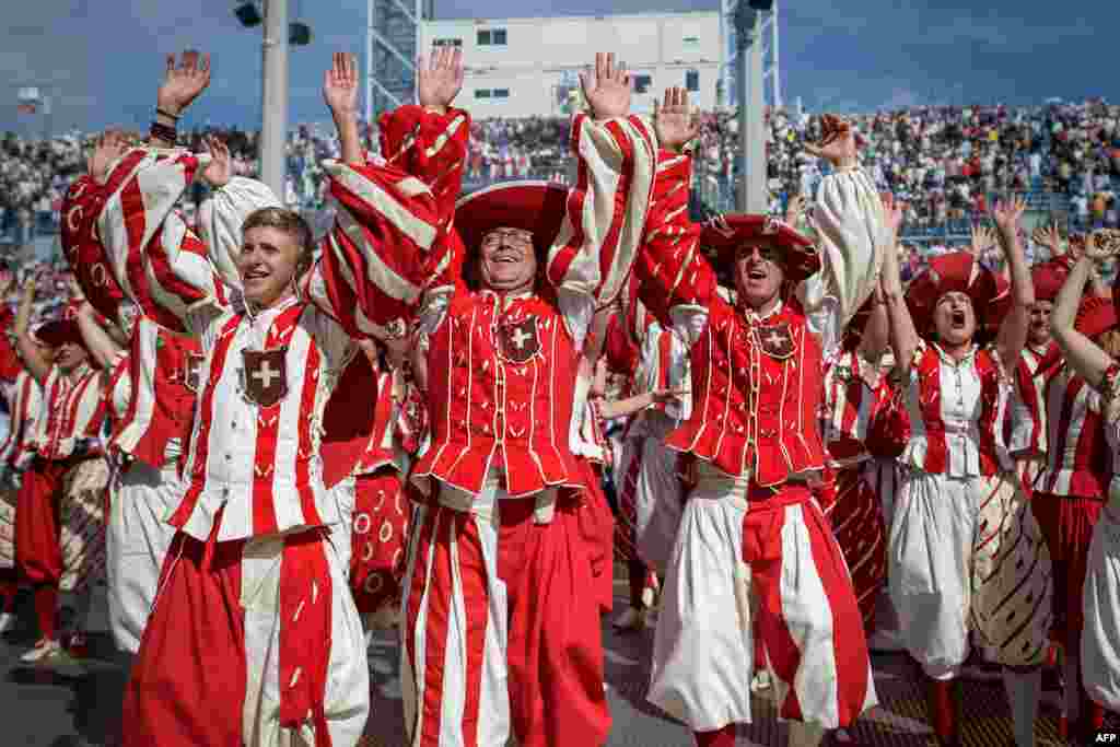 Performers react during celebrations of the Swiss National Day at the Fete des Vignerons (Winegrowers&#39; Festival), a traditional festival that takes place approximately every 25 years in Vevey, Switzerland.