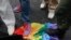 FILE - Anti-gay rights activists stand on a rainbow flag during a protest by gay rights activists demonstrating against a proposed new law termed by the State Duma, the lower house of Parliament, as "against advocating the rejection of traditional family values" in central Moscow, June 11, 2013. 